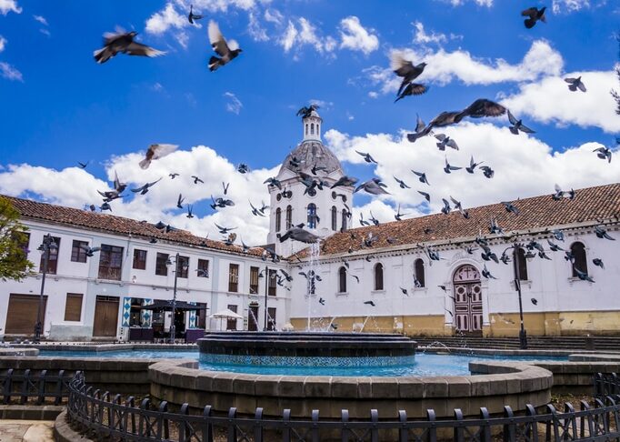 Ecuador, Cuenca city center, scenic view of San Sebastian church with fountain in foreground