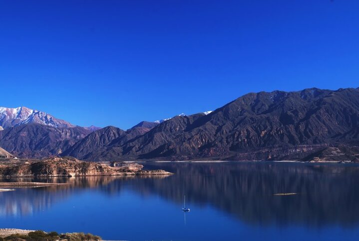 Mendoza landscape. Taken inside Aconcagua provincial park. Shooted from the road looking to a blue water  lake, and behind it, a chain of mountains.  Captured on a winter morning under a clear blue sky.