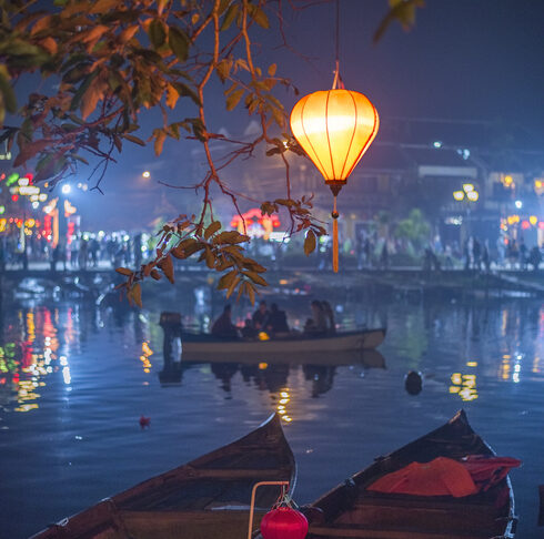 Colorful lanterns light up the riverbank in the picturesque historic city of Hoi An, Vietnam. Every year this popular tourist town is decorated with colorful lanterns during Tet, the Vietnamese New Year.